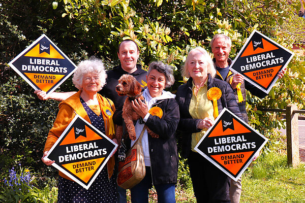 Lib Dem team in the sunshine with banners