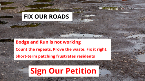 Road with potholes and campaign wording over